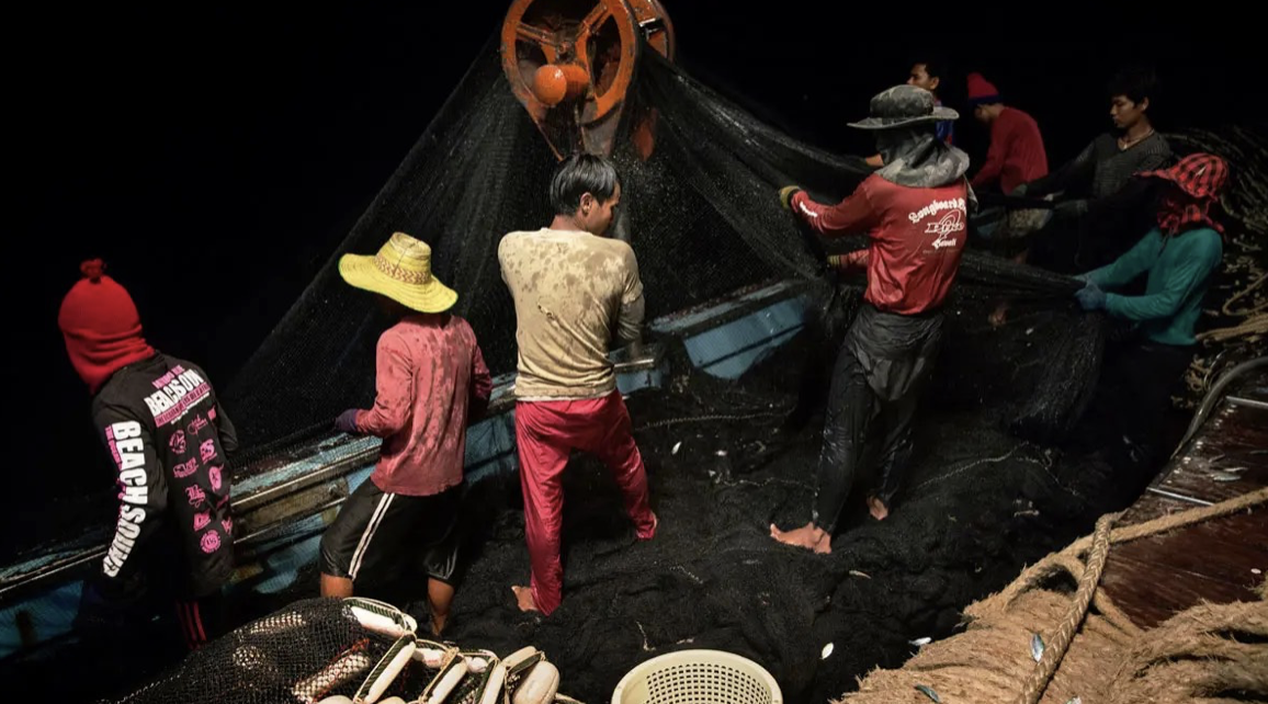 Workers on a fishing vessel — an example of forced labor in the seafood supply chain feeding Western markets