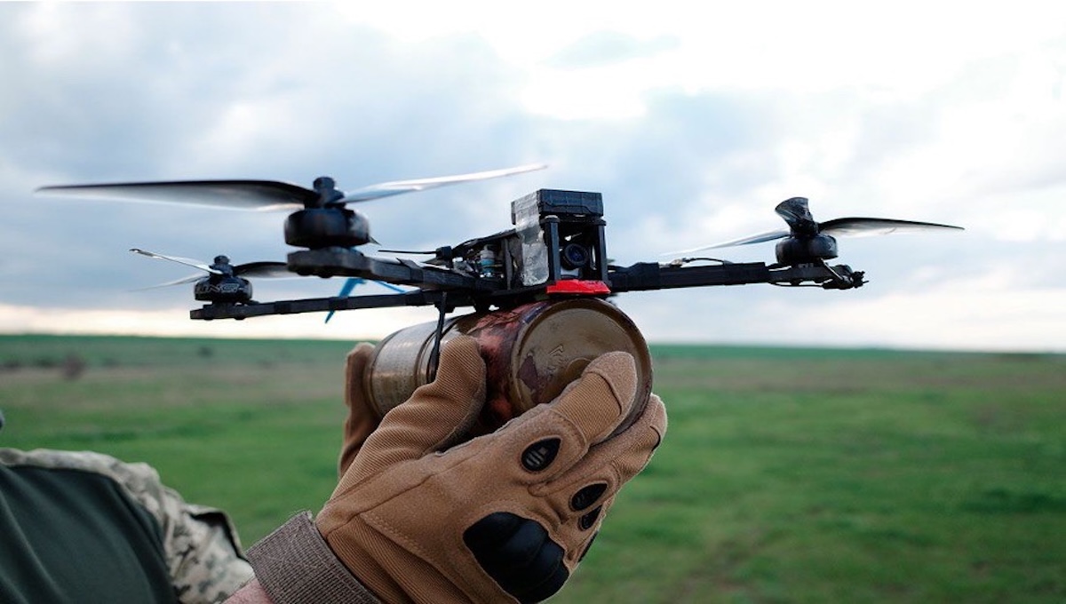 Ukrainian soldier holding an FPV drone close up on the front line