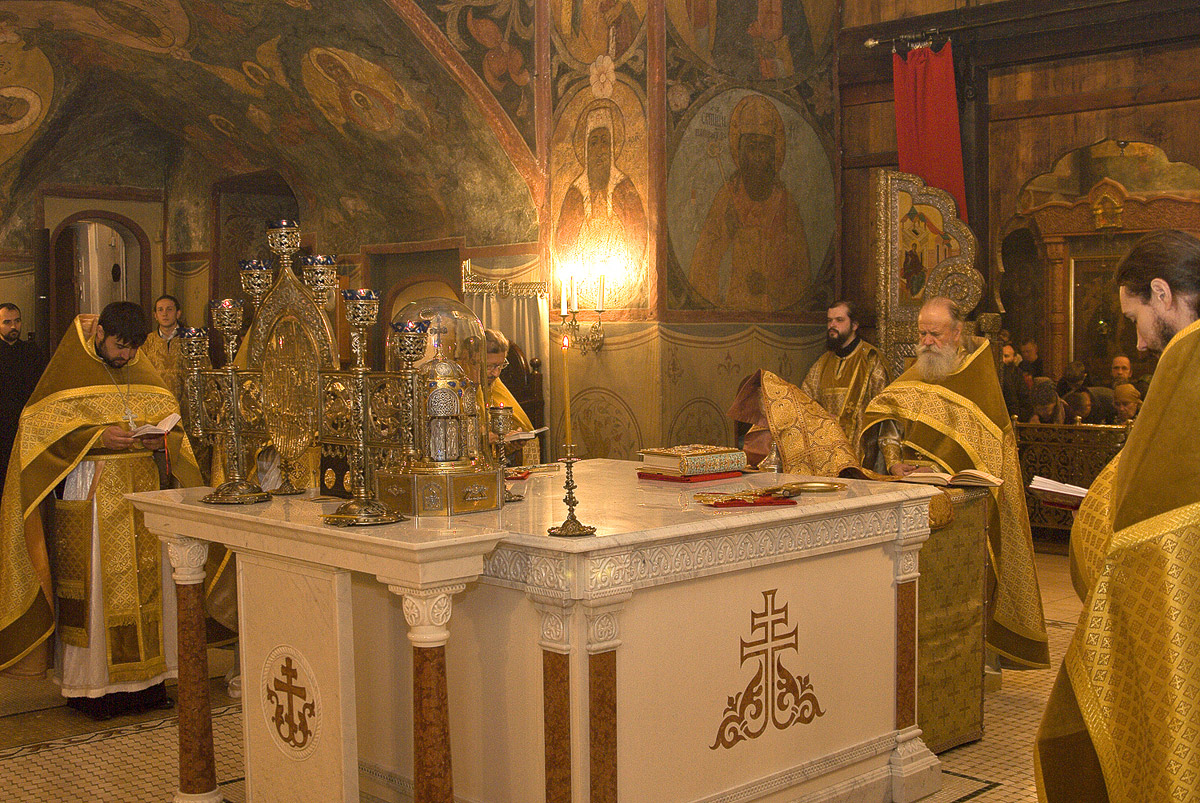 The interior of an Orthodox church with iconostasis, candles and icons representing the sacred space of the Divine Liturgy