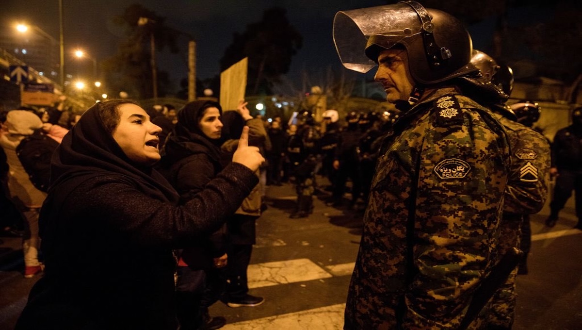 A woman confronting an Iranian guard during protests amid the Starlink internet blackout