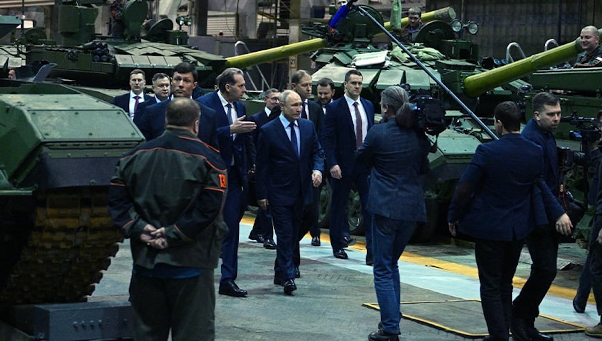 Putin walking through a Russian tank manufacturing facility symbolizing Russia's military buildup