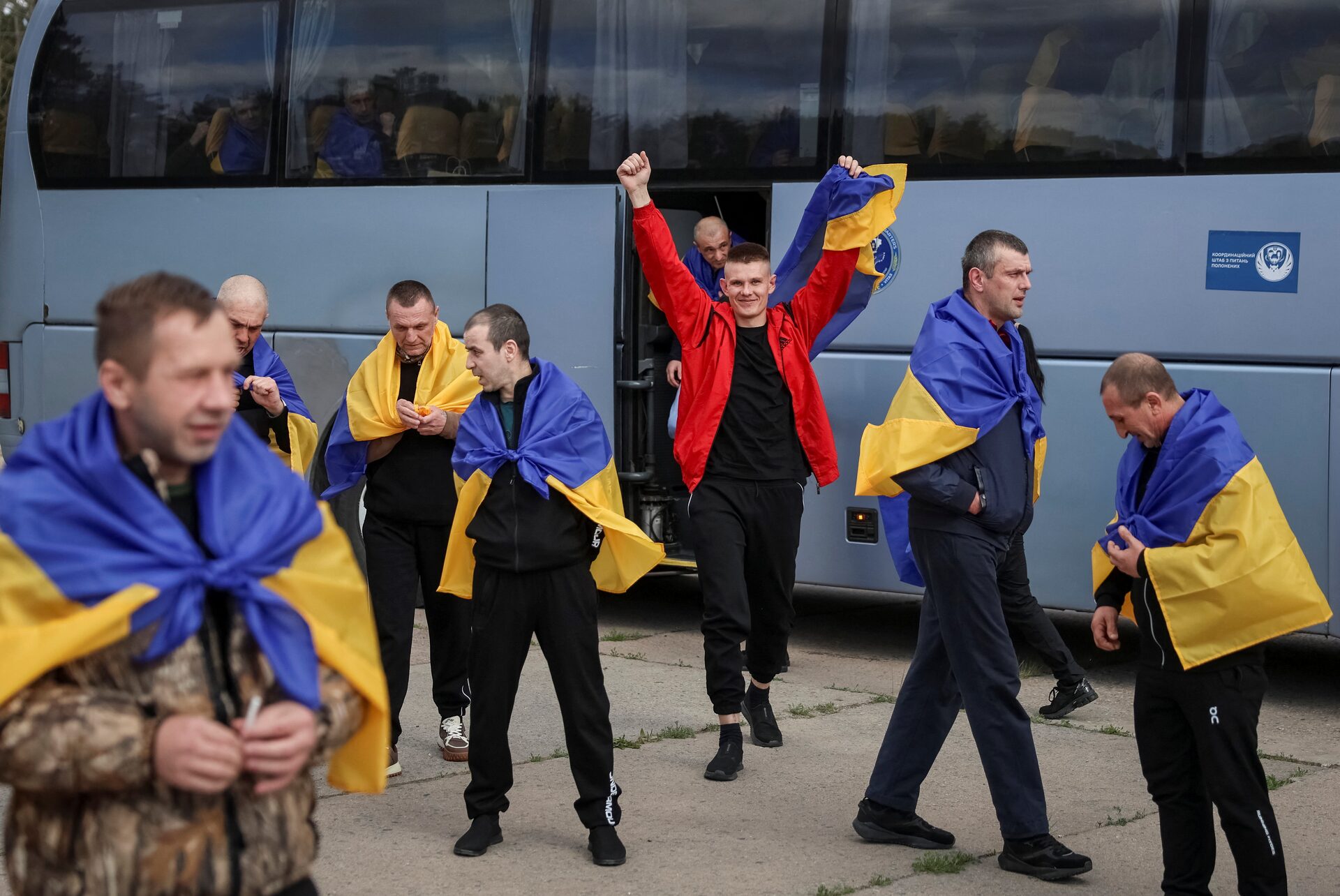 Ukrainian and international officials at a prisoner transfer point during a Russia-Ukraine POW exchange in 2026